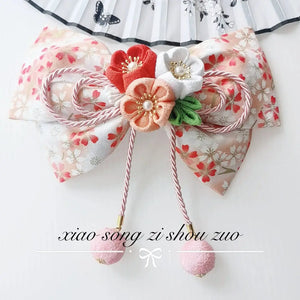 Peach floral Japanese kimono hair accessory with orange and white cherry blossoms and soft pink ball tassels.