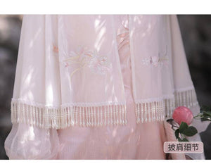 Close-up of pink Feihua Hanfu Cheongsam Dress cape embroidery and pearl fringe, showcasing delicate craftsmanship.