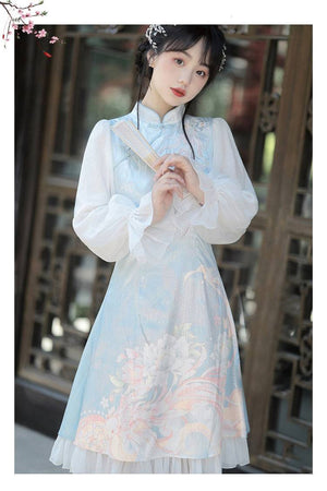 Close-up of Feihua Hanfu Cheongsam Dress in blue, highlighting the floral embroidery and sheer puff sleeves for a delicate aesthetic.