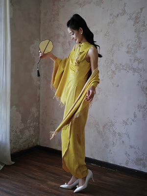Bride in yellow Cheongsam dress with shawl and white heels, styled for a refined wedding look.