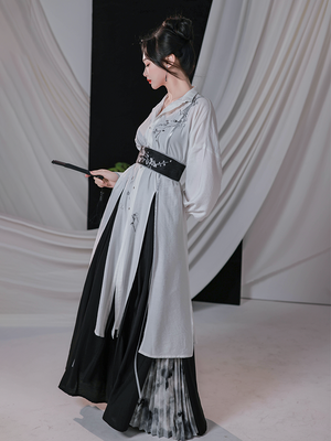 Side view of black and white improved Song pants and embroidered shirt with flowing silhouette, showcasing modern Hanfu elegance.