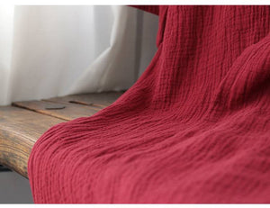 Close-up of the lower part of the red Zen robe, showcasing the soft, crinkled cotton fabric perfect for summer nightgowns.