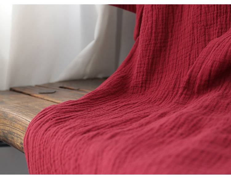Close-up of the lower part of the red Zen robe, showcasing the soft, crinkled cotton fabric perfect for summer nightgowns.