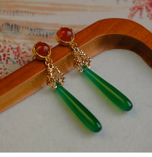 Refined green agate drop earrings with red gemstone tops and gold filigree, perfect for pairing with cheongsam or Hanfu clothing.