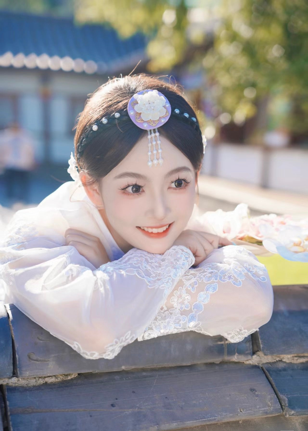 Close-up of white purple Korean female high-end genuine Yanji court hanbok with floral headpiece, smiling over traditional rooftop.