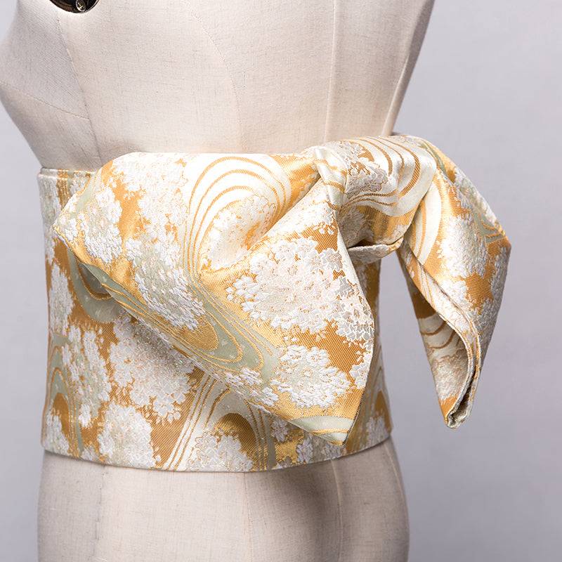 Elegant gold Japanese kimono waist seal with brocade bow, perfect yukata belt for traditional styling and formal occasions.