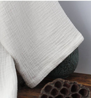 Hem detail of Chinese style pure white Hanfu robe, showcasing soft cotton weave for premium homewear comfort.