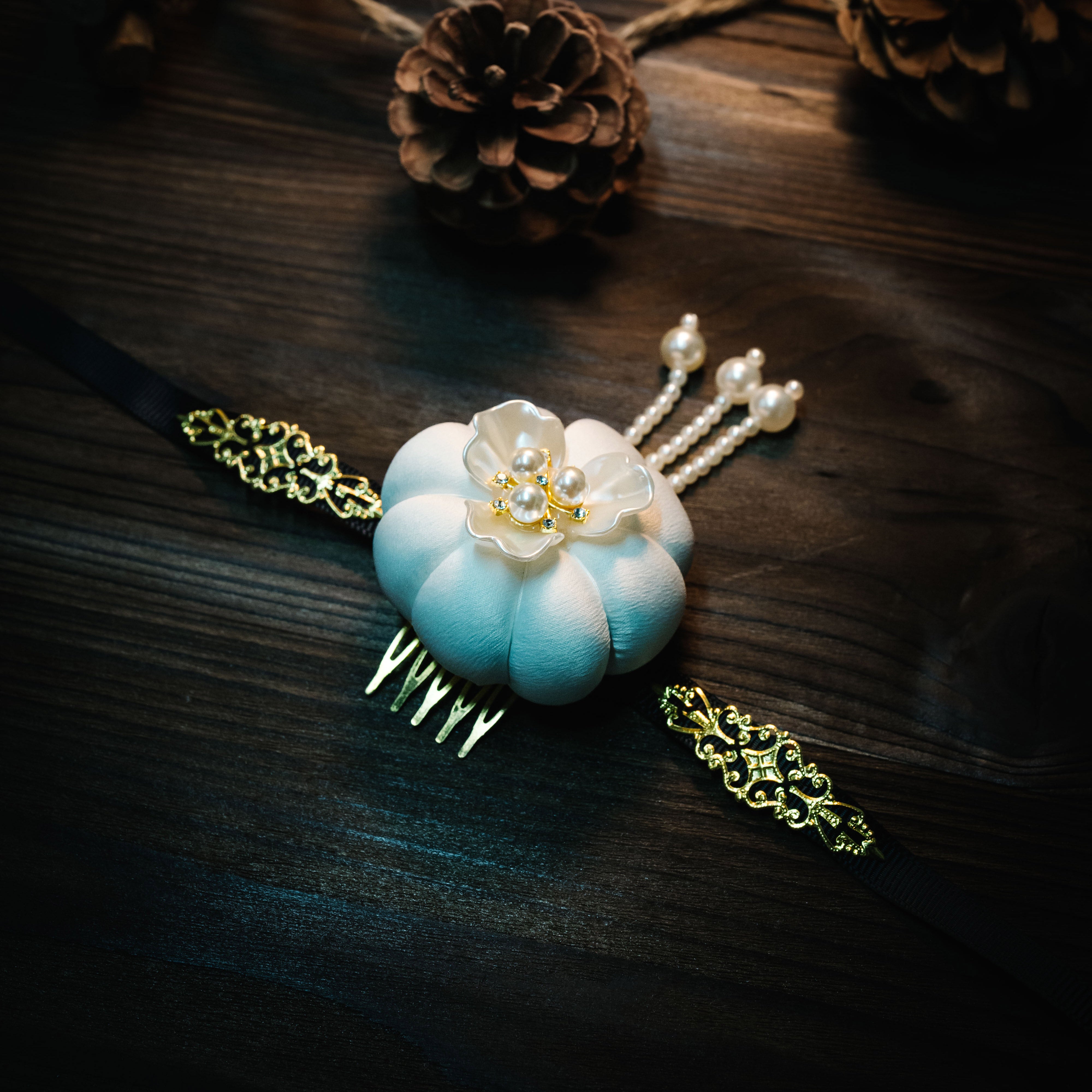 White Hanbok headdress with pearl and floral accents, featuring Yanji Folk Korean tradition design on dark wood background.