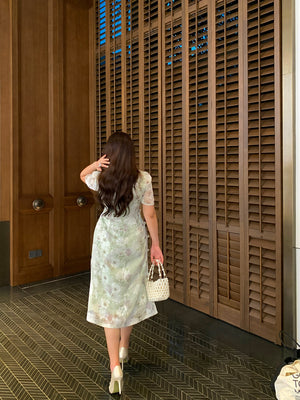 Back view of modern green plus size qipao dress with subtle floral pattern, showcasing elegant silhouette and soft fabric flow.