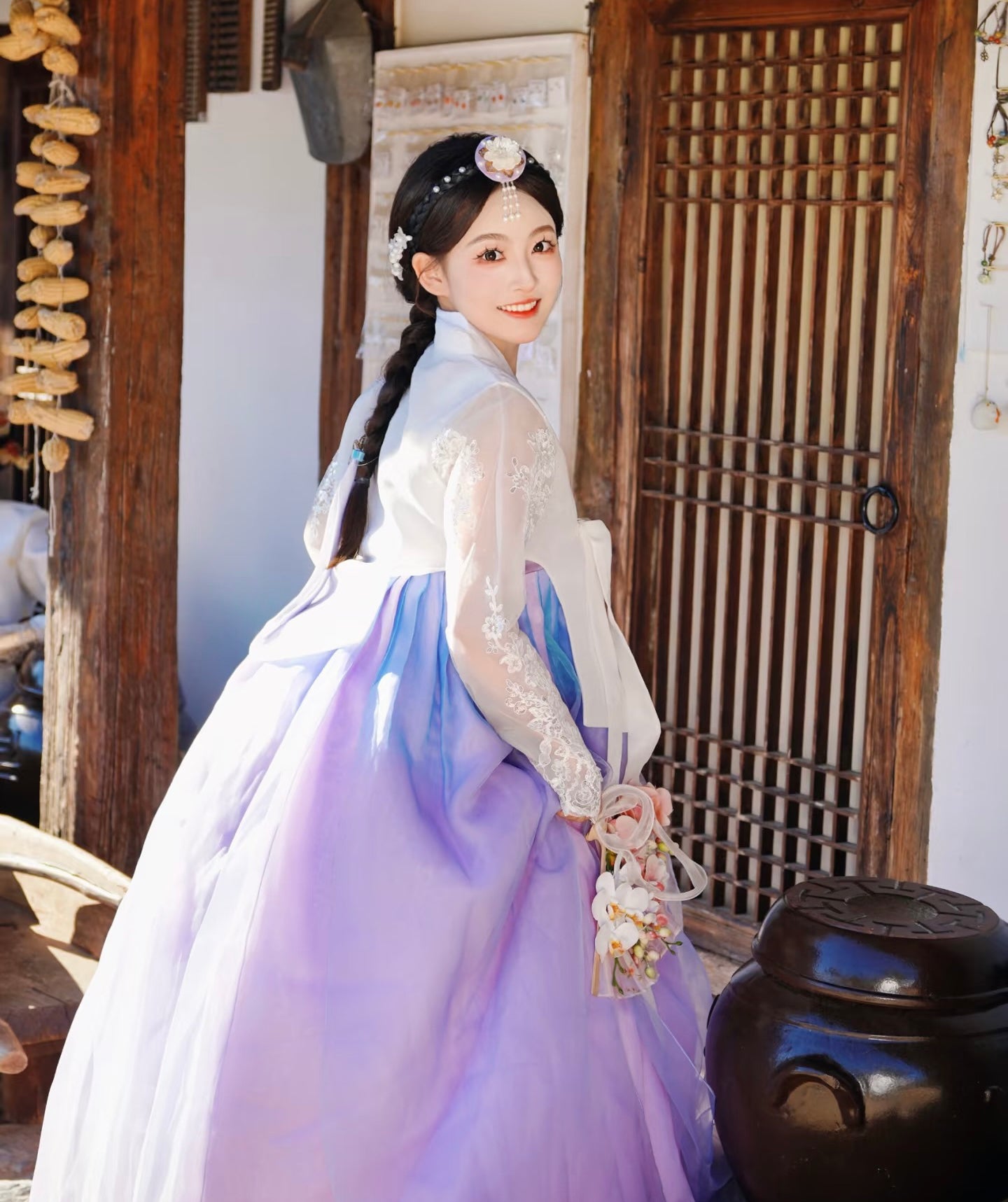 Elegant white purple Korean female high-end genuine Yanji court hanbok with lace details, shown from back view in heritage courtyard.