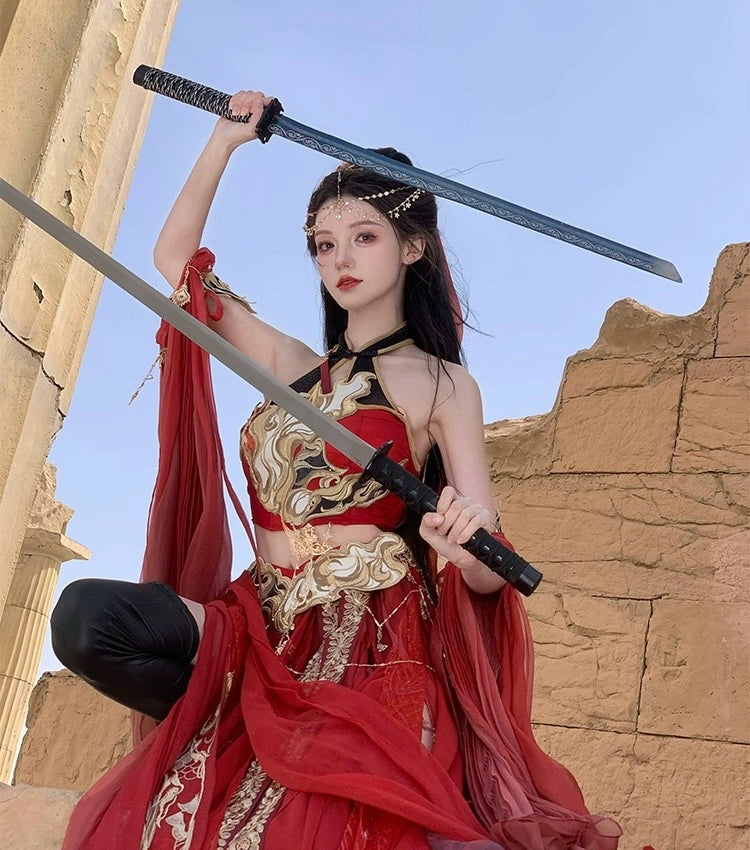 Red Sacred Flame Western Regions Dancer Hanfu with gold accents, modeled in warrior stance holding two swords near ancient ruins.