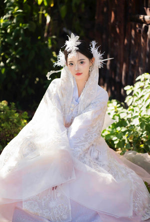 Sitting pose in White&Pink hanbok Korean dress with floral veil, designed for women’s high-end celebrity court dress and events.