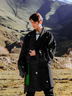 Men's black Kangba Tibetan robe with belt in mountain landscape