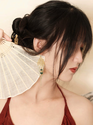 Su Mask Ear Clips - Hanfu Gold Tassel Earrings with intricate floral filigree and green beads, styled with fan and traditional red outfit.