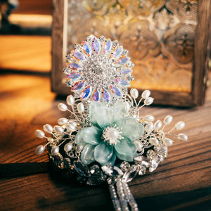 Close-up of Korean traditional ethnic headgear featuring iridescent crystal flower and jade-like bloom, perfect for Korean princess hair styling.