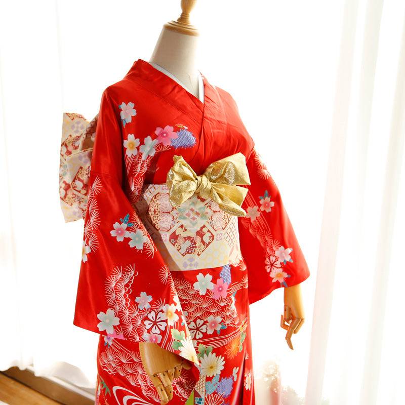 Front angle of red kimono with gold-accented cream big three-leaf bow belt. Swinging sleeves and geisha-style belt bag included.