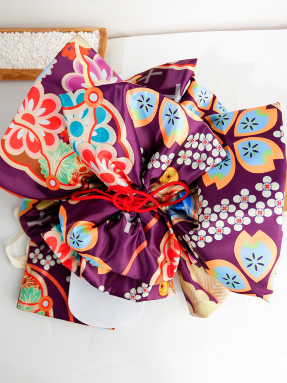 Purple kimono belt with colorful floral big three-leaf bow design. Geisha-inspired accessory perfect for traditional kimono styling.