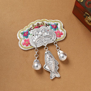 White embroidered Guizhou Miao fridge magnet with silver fish and pearl-like fringe, handmade cultural refrigerator accessory.