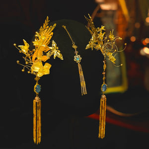 Close-up of Chinese dragonfly hairpin set with gold floral details and blue gemstone, perfect for engagement accessories.