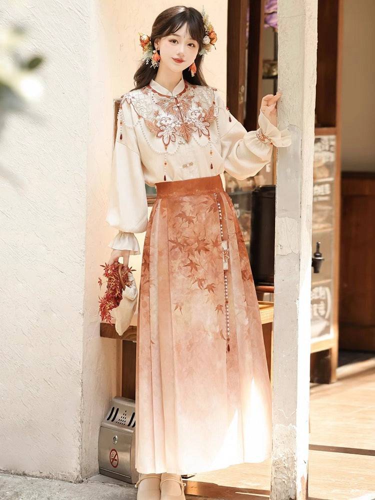 Modern Hanfu ensemble with embroidered top and maple leaf print skirt, blending traditional Chinese style with daily wear comfort.