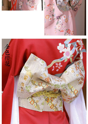 Gold floral brocade bow belt styled with red kimono, ideal for traditional Japanese yukata styling and cultural photography.