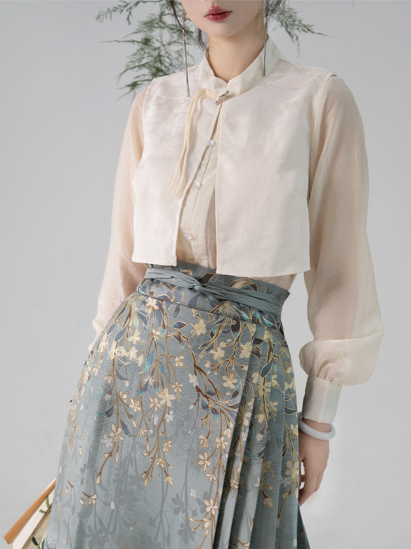 Close-up of floral embroidery on Ming-dynasty Hanfu horse skirt, showcasing gold thread detailing and high-waisted wrap design.