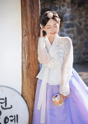 White purple Korean female high-end genuine Yanji court hanbok with embroidered top and purple skirt, model holding traditional drum.