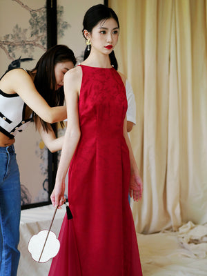 Model being styled in red yarn cheongsam wedding dress, showcasing elegant bridal fashion for toasting or engagement.