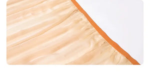Close-up of sheer fabric with orange trim