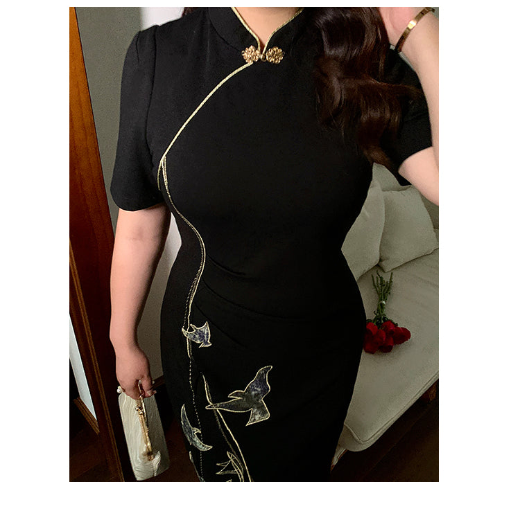 Close-up of black plus size cheongsam dress with gold embroidery and mandarin collar, highlighting detailed craftsmanship.