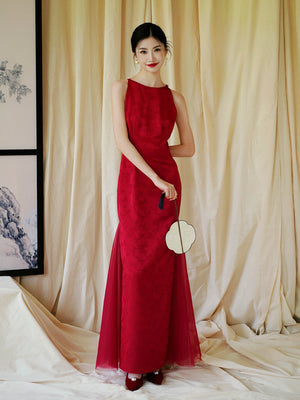 Bride in red cheongsam dress with floral embroidery, styled for wedding or engagement celebrations.