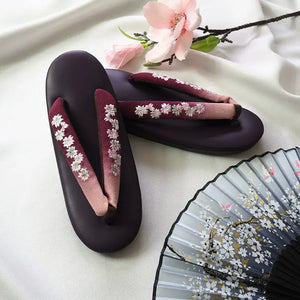 Burgundy Japanese kimono slippers with white floral embroidery and gradient herringbone straps. A sophisticated addition to traditional attire.
