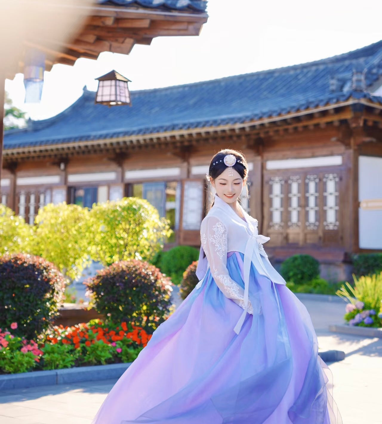 White purple Korean female high-end genuine Yanji court hanbok flowing in sunlight, posed in front of Korean palace garden.