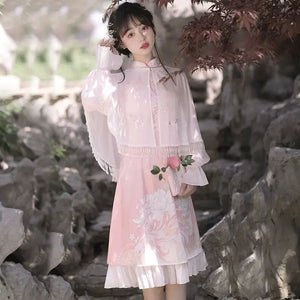 Model in pink Feihua Hanfu Cheongsam Dress with floral embroidery and sheer cape, styled with a peach for a soft feminine look.