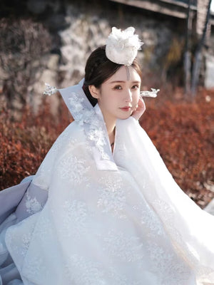 Traditional Korean White Yanji Hanbok court dress with lace details and floral accessories, perfect for cultural or ceremonial occasions.