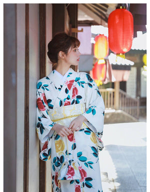 White floral yukata paired with a yellow brocade bow belt, highlighting the elegance of a Japanese kimono waist seal.