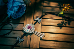 Korean traditional headgear with pink rose, pearl accents, and butterfly charm, designed for hanbok and cultural styling.