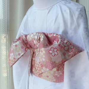 Detailed view of pink floral brocade bow on kimono waist seal, styled on white kimono. 120cm reversible cotton canvas accessory.