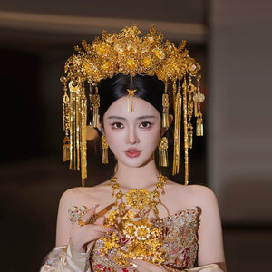 Bride in golden floral headdress and jewelry set, styled for traditional Chinese wedding hair accessory fashion.