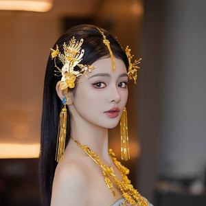 Side view of gold Chinese dragonfly hairpin with delicate embellishments and long tassels for engagement attire.
