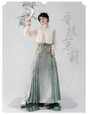 Model wearing Ming-dynasty Hanfu skirt with weeping silk jasmine print and gold accents, styled with a cropped cream vest.
