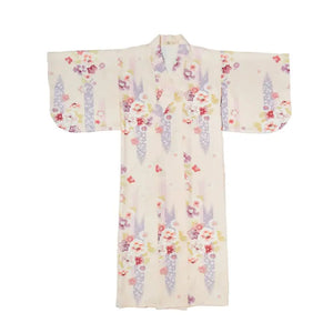 Flat lay of a beige Japanese kimono dress with cherry blossom patterns. A refined yukata for women, ideal for traditional celebrations.