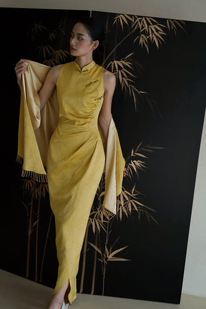Elegant bridal Cheongsam in yellow with dark pattern and shawl, ideal for Chinese wedding ceremonies.