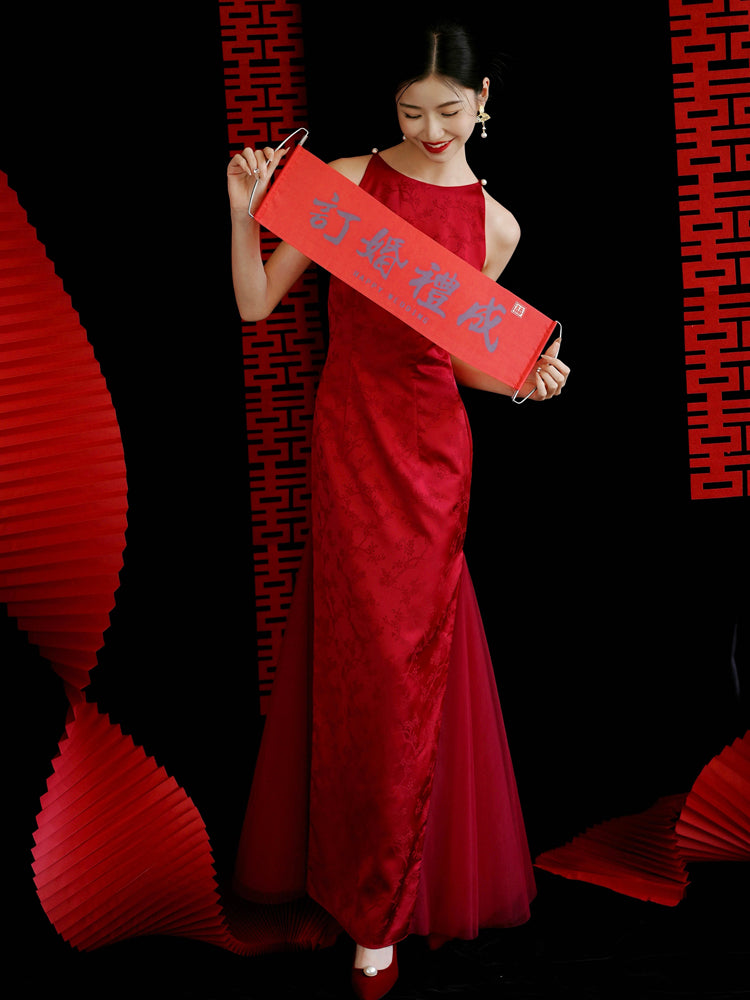 Bride holding red wedding scroll in red cheongsam dress, ideal for engagement or toasting ceremonies.