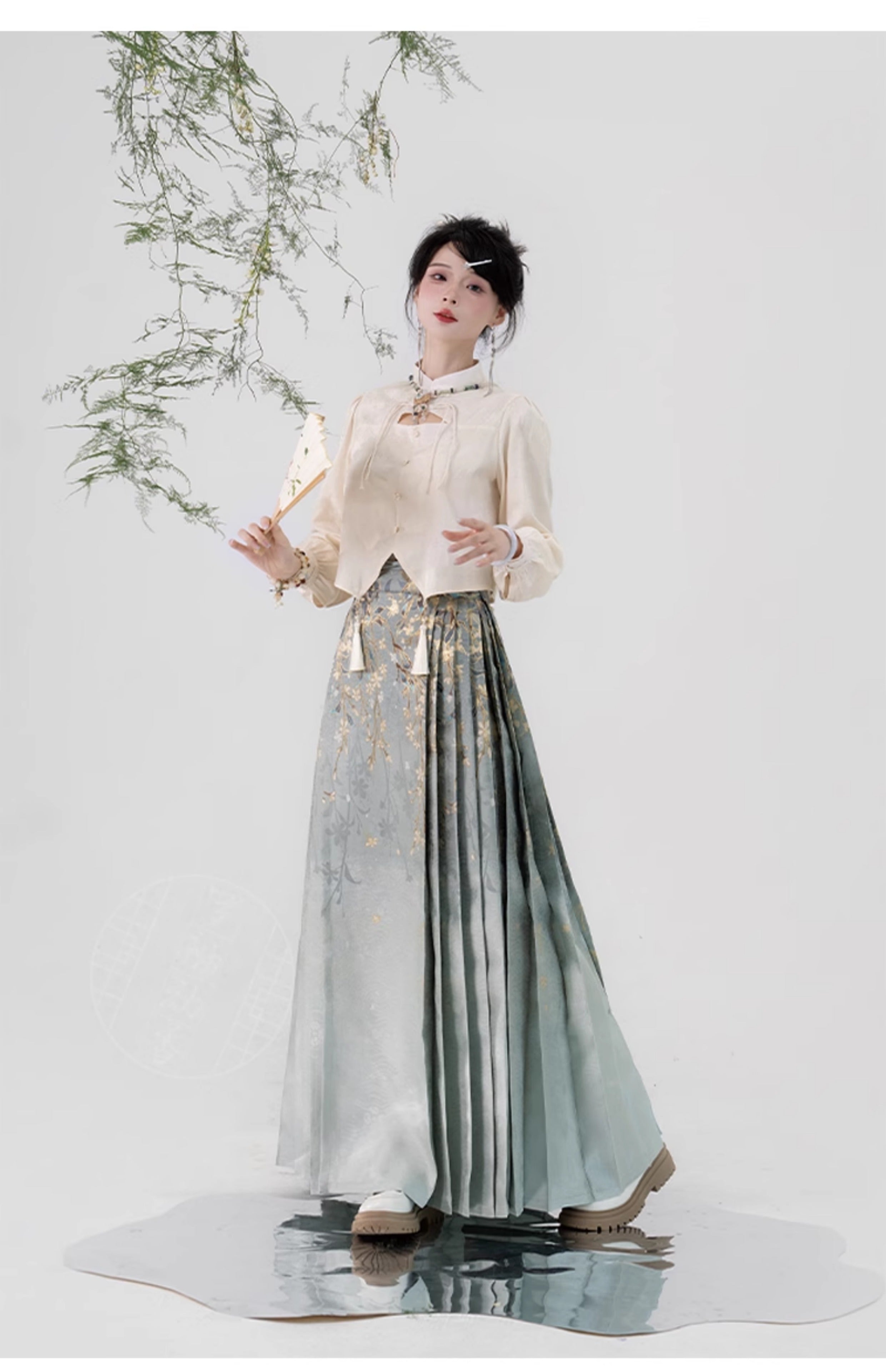 Model poses in Ming-dynasty Hanfu skirt with gold floral design and pleated structure, ideal for cultural performances.