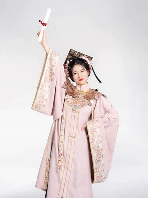 Pink Chinese-style graduation outfit with square tassel hat and diploma scroll