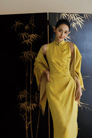 Traditional Yellow Cheongsam Wedding Dress with shawl, showcasing refined bridal elegance and cultural charm.