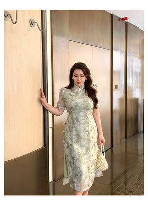 Modern Chinese green plus size cheongsam with delicate floral embroidery and side frog buttons, styled for a refined fashion look.