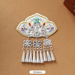 White embroidered Guizhou Miao fridge magnet with silver cone fringe, 10x8cm, handmade ethnic refrigerator ornament.