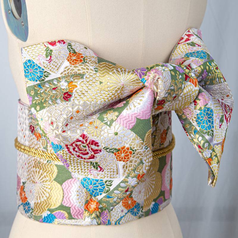 Colorful brocade bow belt with floral and geometric patterns, perfect as a Japanese kimono waist seal for yukata styling and festive wear.